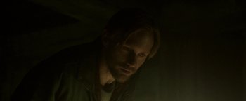 Movie still from “Hidden” (2015), directed by Ross Duffer – A person with long blonde hair; Close Up shot, High angle