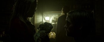 Movie still from “Hidden” (2015), directed by Ross Duffer – A group of people in a dark room; Medium shot, Over the shoulder angle