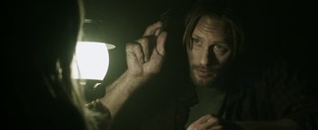 Movie still from “Hidden” (2015), directed by Ross Duffer – A person holding a light; Close Up shot, Low angle