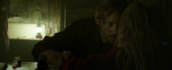 Movie still from “Hidden” (2015), directed by Ross Duffer – A man and a woman in a dark room looking at each other; Close Up shot, Over the shoulder angle