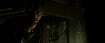 Movie still from “Hidden” (2015), directed by Ross Duffer – A man standing next to a wall in a dark room; Close Up shot, Over the shoulder angle