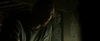 Movie still from “Hidden” (2015), directed by Ross Duffer – A person with long brown hair; Close Up shot, Low angle