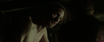 Movie still from “Hidden” (2015), directed by Ross Duffer – A person in a dark room; Close Up shot, Over the shoulder angle