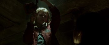 Movie still from “Hidden” (2015), directed by Ross Duffer – A young girl holding her arms up in the dark; Close Up shot, Low angle
