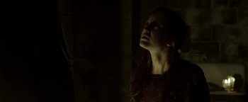 Movie still from “Hidden” (2015), directed by Ross Duffer – A woman with long red hair looking up at the sky; Close Up shot, Low angle