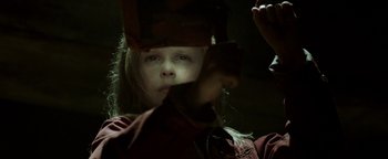 Movie still from “Hidden” (2015), directed by Ross Duffer – A young girl looking into a mirror in a dark room; Close Up shot, Low angle