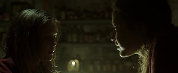 Movie still from “Hidden” (2015), directed by Ross Duffer – A man and a woman face to face in a dark room; Close Up shot, Over the shoulder angle