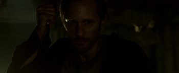 Movie still from “Hidden” (2015), directed by Ross Duffer – A person in a dark room; Close Up shot, High angle