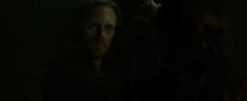 Movie still from “Hidden” (2015), directed by Ross Duffer – A man in a dark room looking at the camera; Close Up shot, Over the shoulder angle