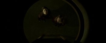 Movie still from “Hidden” (2015), directed by Ross Duffer – Two young children are looking up at the camera; Wide shot, Overhead angle