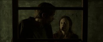 Movie still from “Hidden” (2015), directed by Ross Duffer – A man and a woman looking at each other through a window; Close Up shot, Low angle