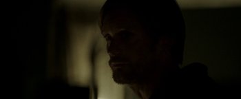 Movie still from “Hidden” (2015), directed by Ross Duffer – A person's face in the dark; Close Up shot, Over the shoulder angle