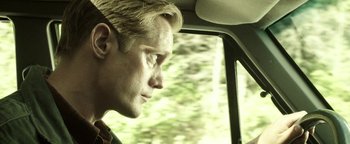 Movie still from “Hidden” (2015), directed by Ross Duffer – A person in a car looking out the window; Close Up shot, Low angle