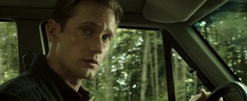 Movie still from “Hidden” (2015), directed by Ross Duffer – A person in a car looking out of the window; Close Up shot, Over the shoulder angle