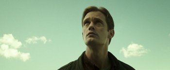 Movie still from “Hidden” (2015), directed by Ross Duffer – A person looking up at the sky; Close Up shot, Low angle