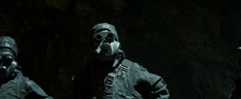 Movie still from “Hidden” (2015), directed by Ross Duffer – A man wearing a gas mask in the dark; Close Up shot, Low angle
