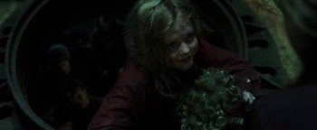 Movie still from “Hidden” (2015), directed by Ross Duffer – A young girl holding a stuffed animal in a dark room; Close Up shot, Over the shoulder angle