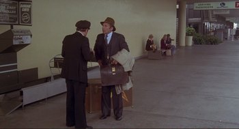 Movie still from “High Anxiety” (1977), directed by Mel Brooks – Two men in suits and hats are shaking hands; Wide shot, High angle