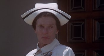 Movie still from “High Anxiety” (1977), directed by Mel Brooks – A woman wearing a white hat and a white shirt; Close Up shot, Low angle