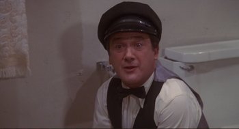 Movie still from “High Anxiety” (1977), directed by Mel Brooks – A man wearing a black hat and bow tie; Medium shot, Low angle
