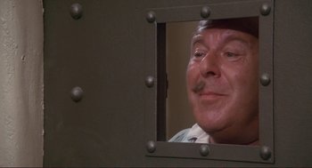 Movie still from “High Anxiety” (1977), directed by Mel Brooks – A person looking through a window; Close Up shot, High angle
