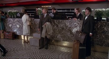Movie still from “High Anxiety” (1977), directed by Mel Brooks – A group of people standing in a room; Wide shot, High angle
