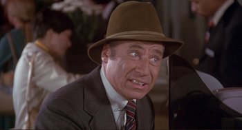 Movie still from “High Anxiety” (1977), directed by Mel Brooks – A man in a suit and a hat is crying; Close Up shot, High angle