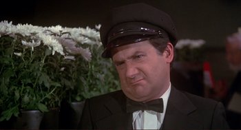 Movie still from “High Anxiety” (1977), directed by Mel Brooks – A person wearing a suit and a hat; Close Up shot, High angle