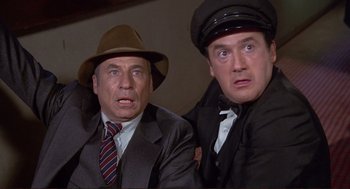 Movie still from “High Anxiety” (1977), directed by Mel Brooks – Two men in suits and hats looking at the camera; Close Up shot, Low angle