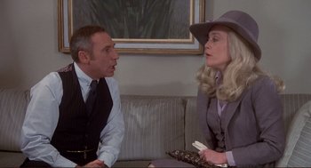 Movie still from “High Anxiety” (1977), directed by Mel Brooks – A man and a woman sitting next to each other on a couch; Medium shot, Over the shoulder angle