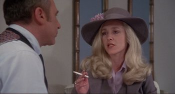 Movie still from “High Anxiety” (1977), directed by Mel Brooks – A woman in a hat is smoking a cigarette; Close Up shot, Over the shoulder angle