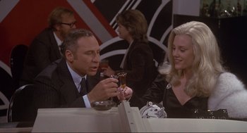Movie still from “High Anxiety” (1977), directed by Mel Brooks – A man and a woman sitting at a table with drinks; Medium shot, High angle