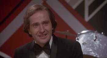 Movie still from “High Anxiety” (1977), directed by Mel Brooks – A person wearing a suit and a bow tie; Close Up shot, Low angle