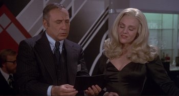 Movie still from “High Anxiety” (1977), directed by Mel Brooks – A man and a woman are looking at a tablet computer; Medium shot, Low angle