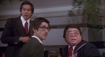 Movie still from “High Anxiety” (1977), directed by Mel Brooks – A group of men standing next to each other in a room; Medium shot, Low angle