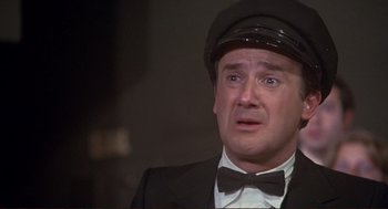 Movie still from “High Anxiety” (1977), directed by Mel Brooks – A person wearing a suit and a hat; Close Up shot, Low angle