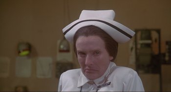 Movie still from “High Anxiety” (1977), directed by Mel Brooks – A woman wearing a white hat with a black stripe on it's brim; Close Up shot, Low angle