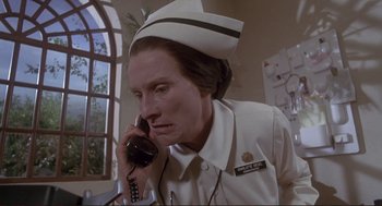 Movie still from “High Anxiety” (1977), directed by Mel Brooks – A woman in a nurse's uniform talking on a phone; Close Up shot, Low angle