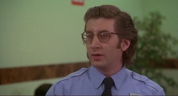 Movie still from “High Anxiety” (1977), directed by Mel Brooks – A person wearing glasses and a tie; Close Up shot, Low angle