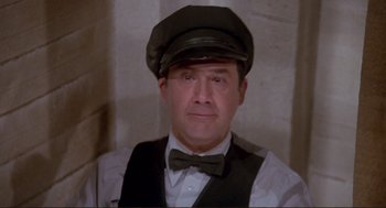 Movie still from “High Anxiety” (1977), directed by Mel Brooks – A person wearing a hat and a bow tie; Close Up shot, Low angle