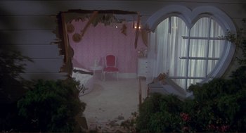 Movie still from “High Anxiety” (1977), directed by Mel Brooks – A room that has been torn down with a pink wall; Wide shot, High angle