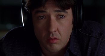 Movie still from “High Fidelity” (2000), directed by Stephen Frears – A man's face in the dark; Close Up shot, Overhead angle