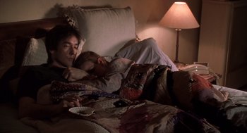 Movie still from “High Fidelity” (2000), directed by Stephen Frears – A woman and a child sleeping on a couch; Medium shot, High angle
