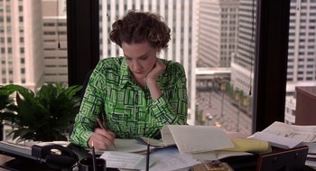Movie still from “High Fidelity” (2000), directed by Stephen Frears – A woman sitting at a desk writing on a piece of paper; Medium shot, High angle