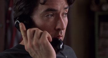 Movie still from “High Fidelity” (2000), directed by Stephen Frears – A person talking on a phone; Close Up shot, Low angle