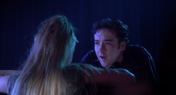 Movie still from “High Fidelity” (2000), directed by Stephen Frears – A man and a woman are talking in a dark room; Close Up shot, Over the shoulder angle