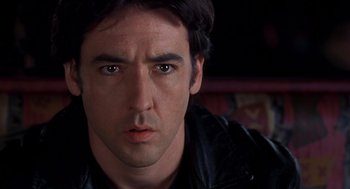 Movie still from “High Fidelity” (2000), directed by Stephen Frears – A person wearing a leather jacket; Close Up shot, Over the shoulder angle