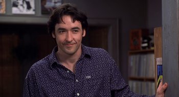 Movie still from “High Fidelity” (2000), directed by Stephen Frears – A person wearing a shirt; Close Up shot, Over the shoulder angle