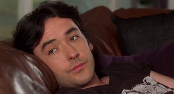 Movie still from “High Fidelity” (2000), directed by Stephen Frears – A person laying on a couch; Close Up shot, High angle