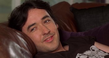 Movie still from “High Fidelity” (2000), directed by Stephen Frears – A person laying on a couch; Close Up shot, Over the shoulder angle